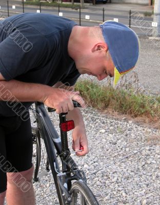 Cyclist adjusting the saddle