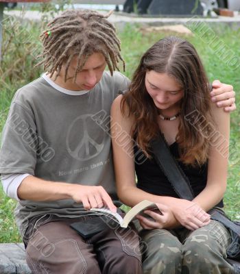 Young stydents reading in street