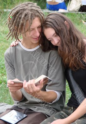 Young stydents reading in street