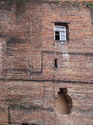 Alone window of aged ruined urban building