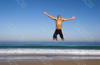 Man running and jumping on the beach