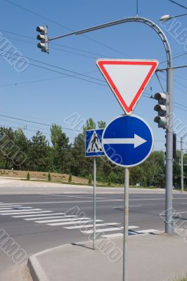 Road signs, traffic lights and pedestrian crossing