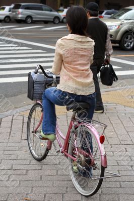 Japanese woman riding bicycle Japanese woman riding bicycle
