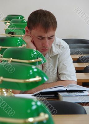 Student reading book in public library