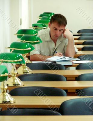 Student reading book in public library