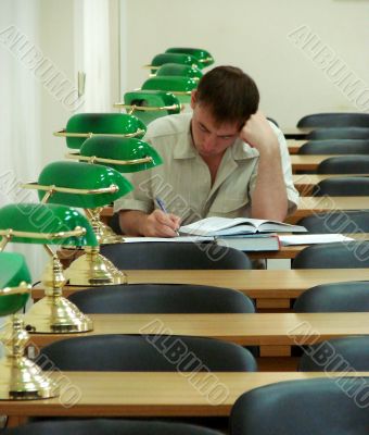 Student reading book in public library