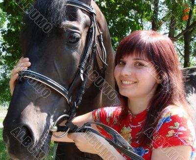 Brunette female model with black horse