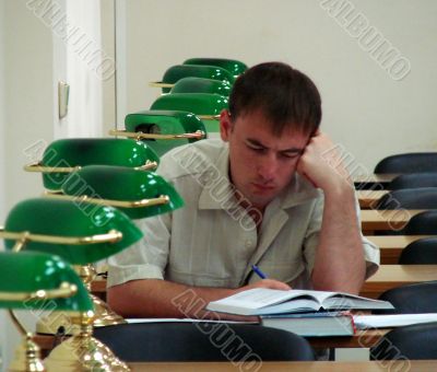 Student reading book in public library