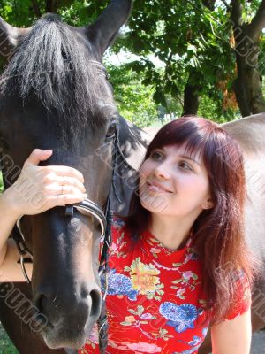 Brunette female model with black horse Brunette female model with black horse