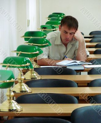 Student reading book in public library