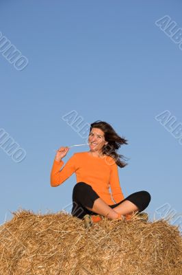 Beautiful woman seated in a field