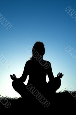 Woman silhouette making yoga