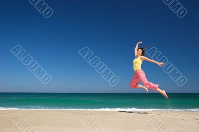 beautiful woman jumping in the beach