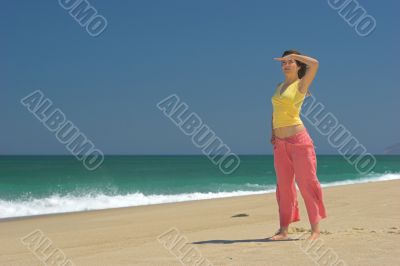 Beautiful woman in the beach watching