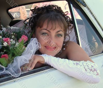 Smiling bride in car window Smiling bride in car window