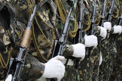 Row of uniformed weaponed soldiers