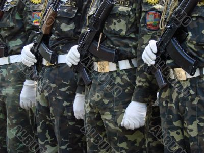 Row of uniformed weaponed soldiers
