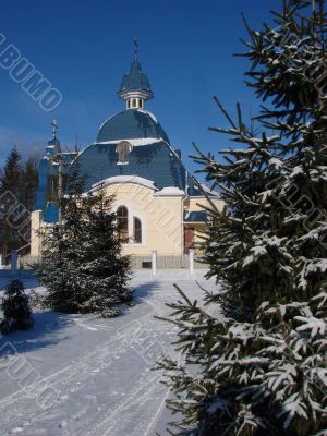 Winter snowy landscape with fur-trees and church