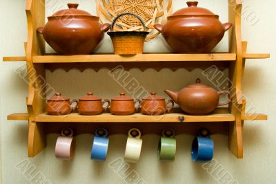 Ceramic utensils on a wooden shelf