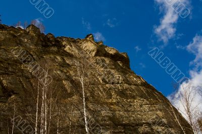 Rocky rock on a background of the sky