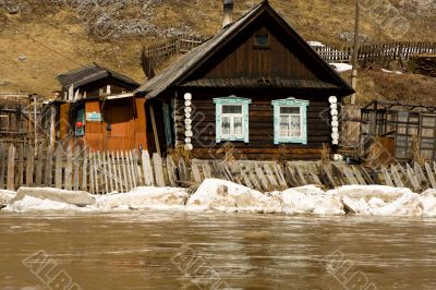 Old house on coast of the spread river