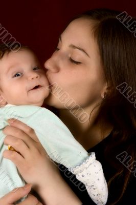 Young mum kissing the favourite son