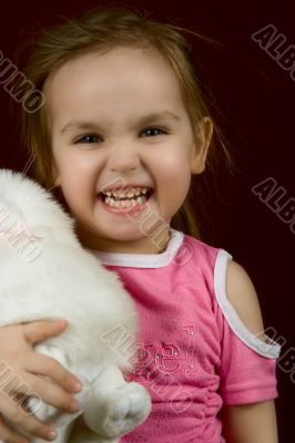 The small artful girl with a toy