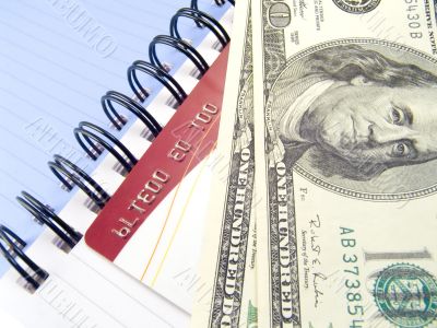 Notebook with dollars and credit card Notebook with dollars and credit card