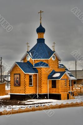 Russian wooden church with a dome and crosses