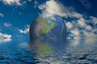 Globe at ocean on a background of clouds