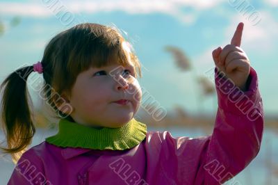 Girl pointing in the sky