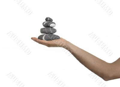 Balanced stones on a man Hand