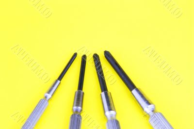 metal screw drivers on yellow