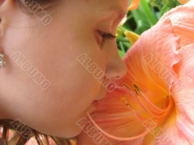 The girl smelling a flower
