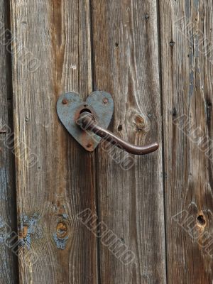 Aged door handle on wooden door