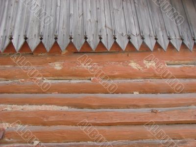 Old log wall and wooden roof