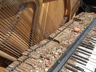 The Old Broken Piano Among Ruins