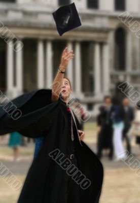 college graduate throwing hat on air
