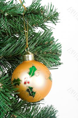 Yellow christmas ball hanging on a tree