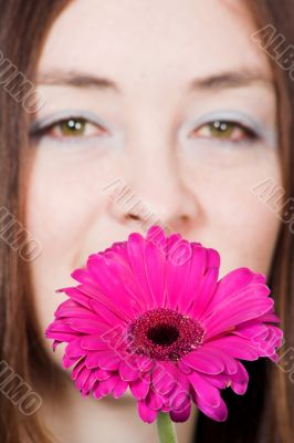 beautiful girl with a purple daisy
