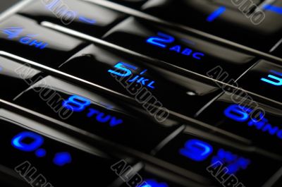 Blue mobile keypad under dark
