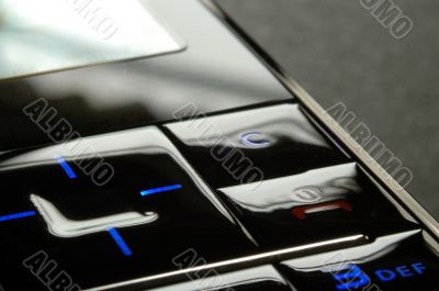 Blue mobile keypad under dark