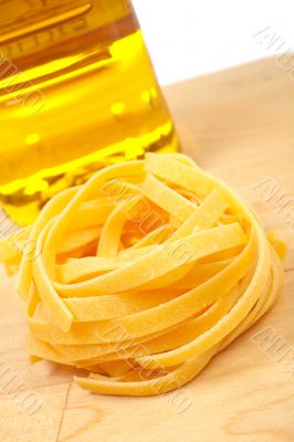 Uncooked pasta nest and oil