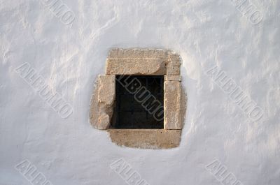 small window  in white lime wall