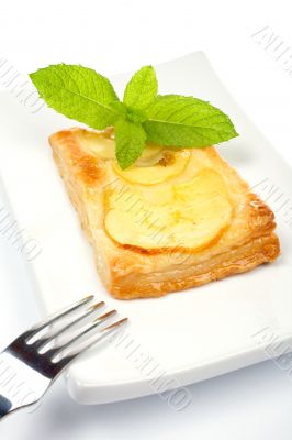 Fork and apple tart on a dish