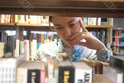 Beautiful student looking for a book