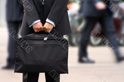 business man holding briefcase at rush hour