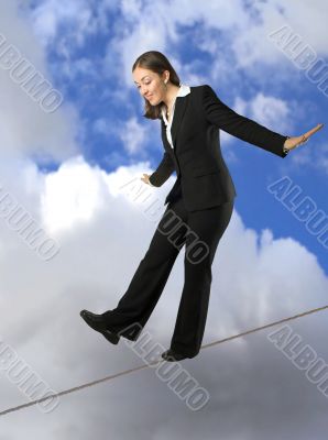 business woman balancing on rope