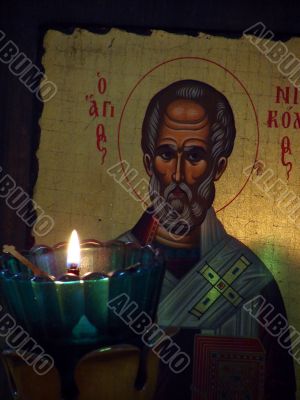 The slavic St Nicolay Icon and burning candle
