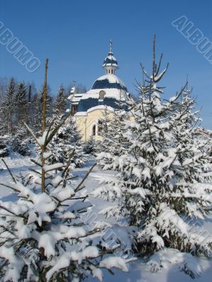 Winter snowy landscape with fur-trees and church